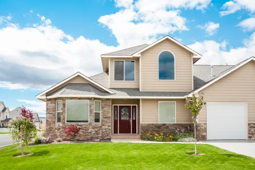 A stone-and-siding family home on a green lot in the Hayden corridor.