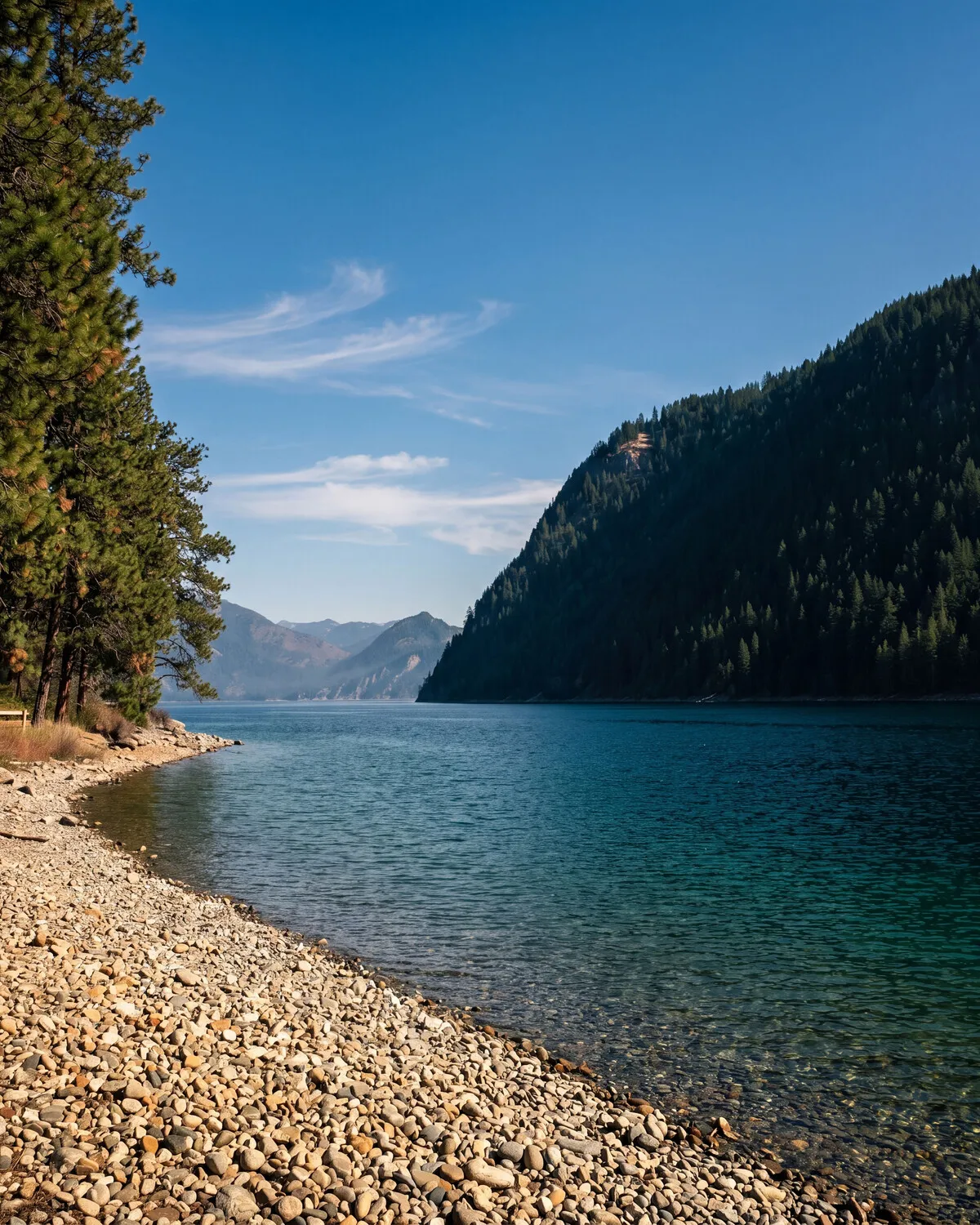 A North Idaho landscape near Farragut, evergreen ridges around an alpine lake.